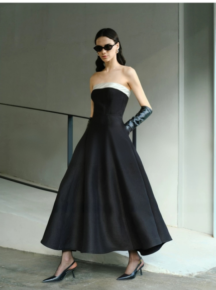 Elegant strapless, waist cinched, big black dress