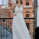 Vacation style hanging neck dress with hollowed out embroidery, exposed back, cinched waist, slimming effect, and large A-line long skirt