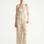 Embroidered asymmetrical top with wavy shoulder straps and beaded fake two-piece straps