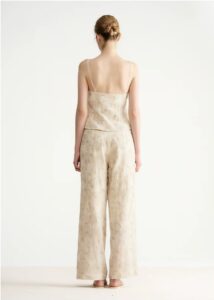 Embroidered asymmetrical top with wavy shoulder straps and beaded fake two-piece straps